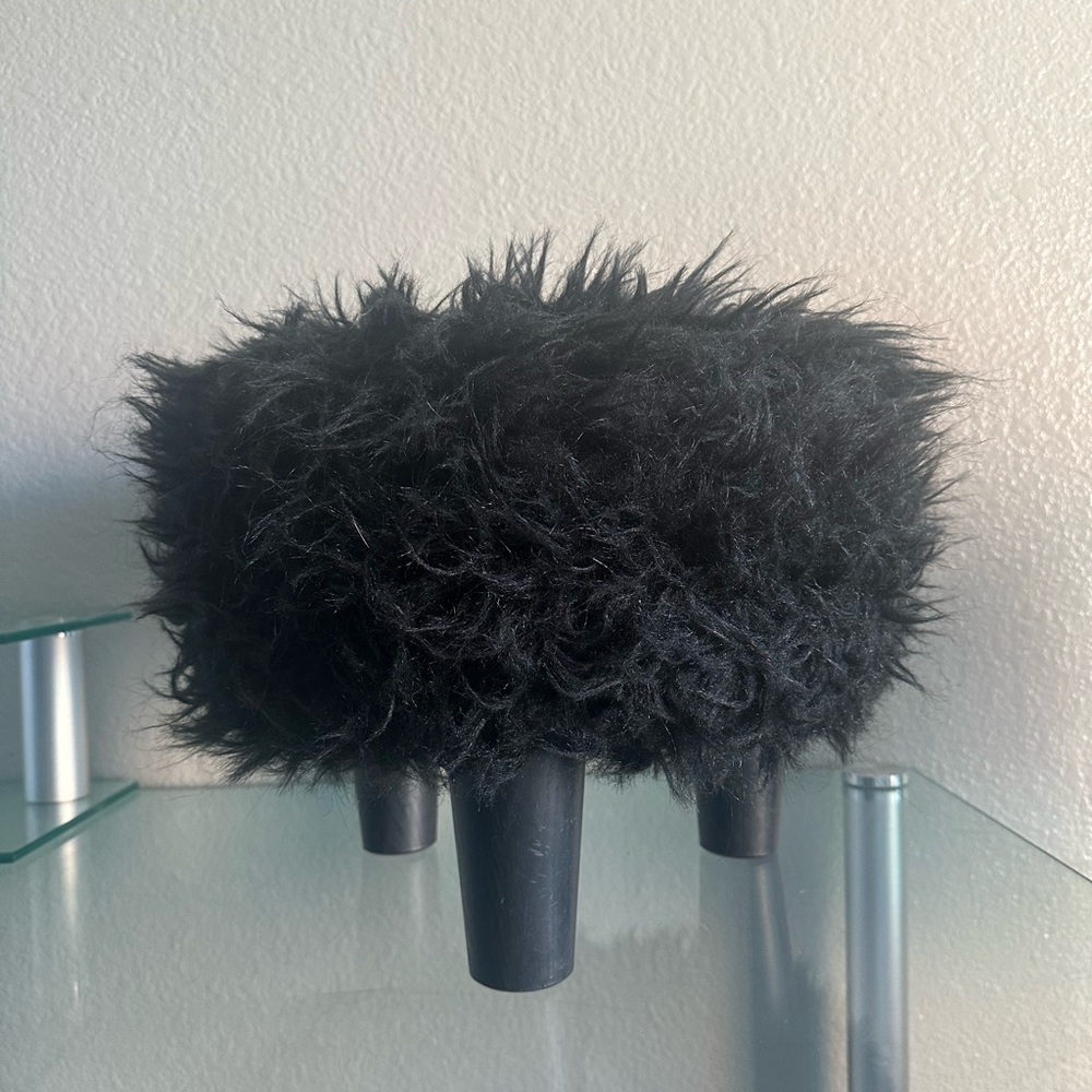 black faux fur ottoman/stool with 3 wooden legs